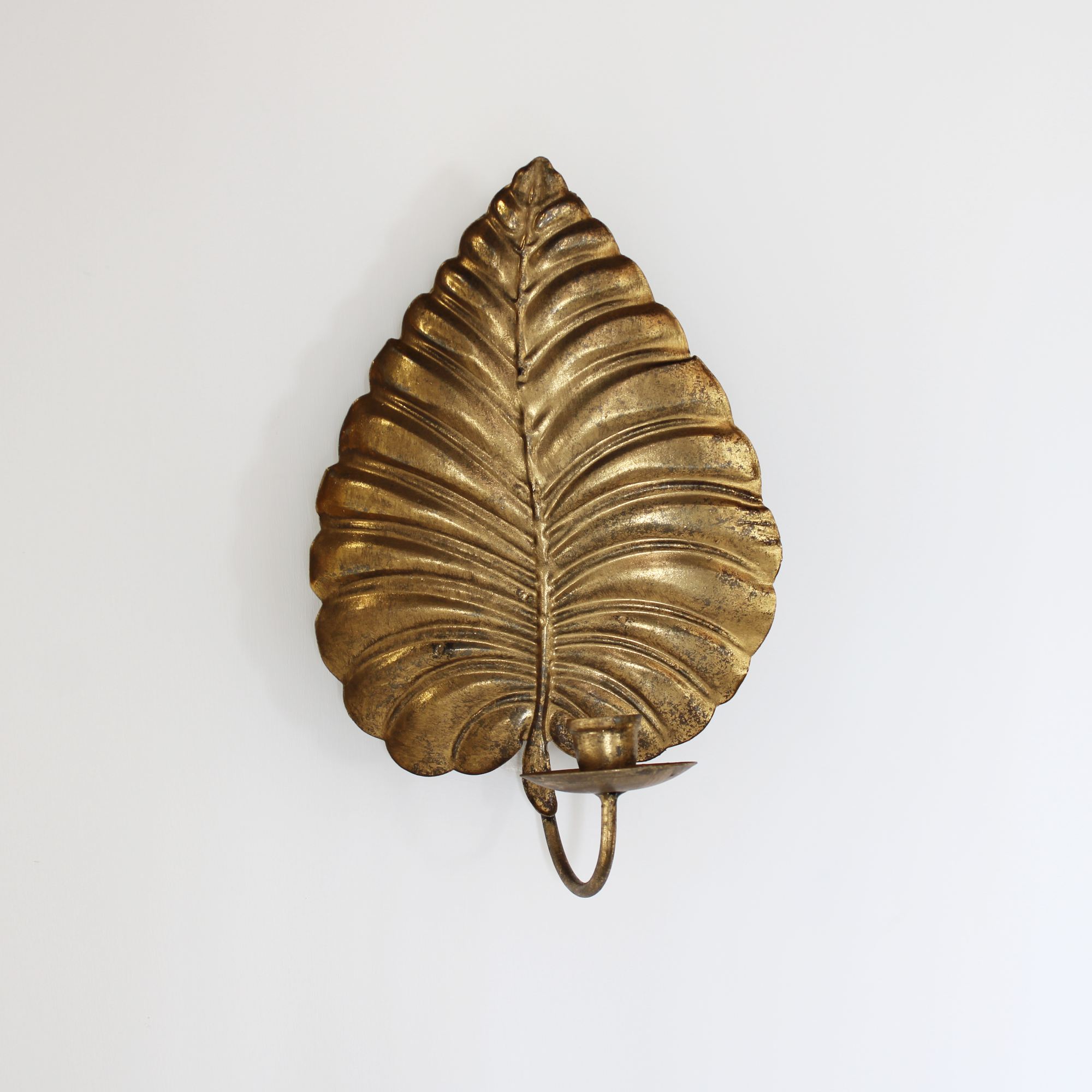 Gold metal wall sconce candle holder for rustic or vintage home décor.