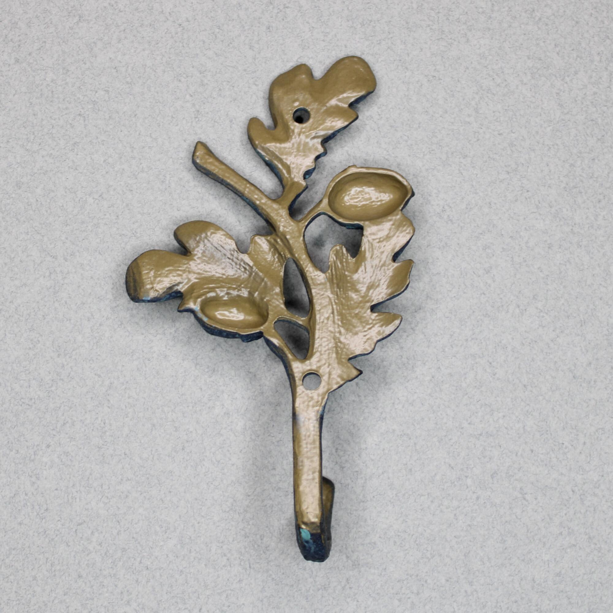 Back of metal oak leaf wall hook showing mounting holes and hollow cast design