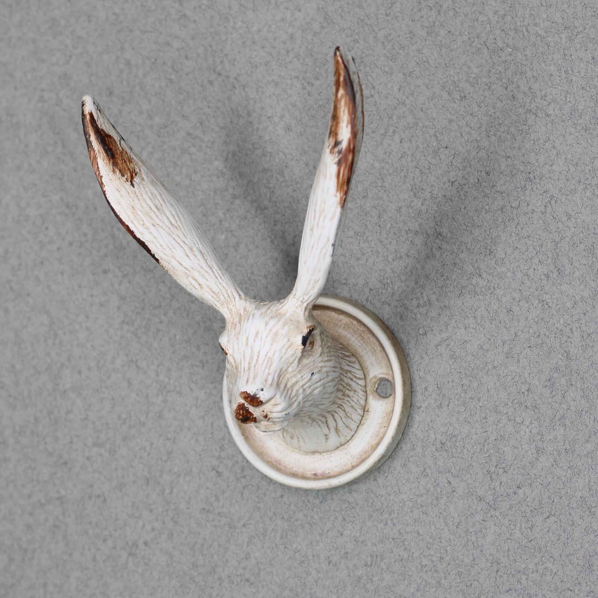 Vintage white hare wall hook with weathered finish.