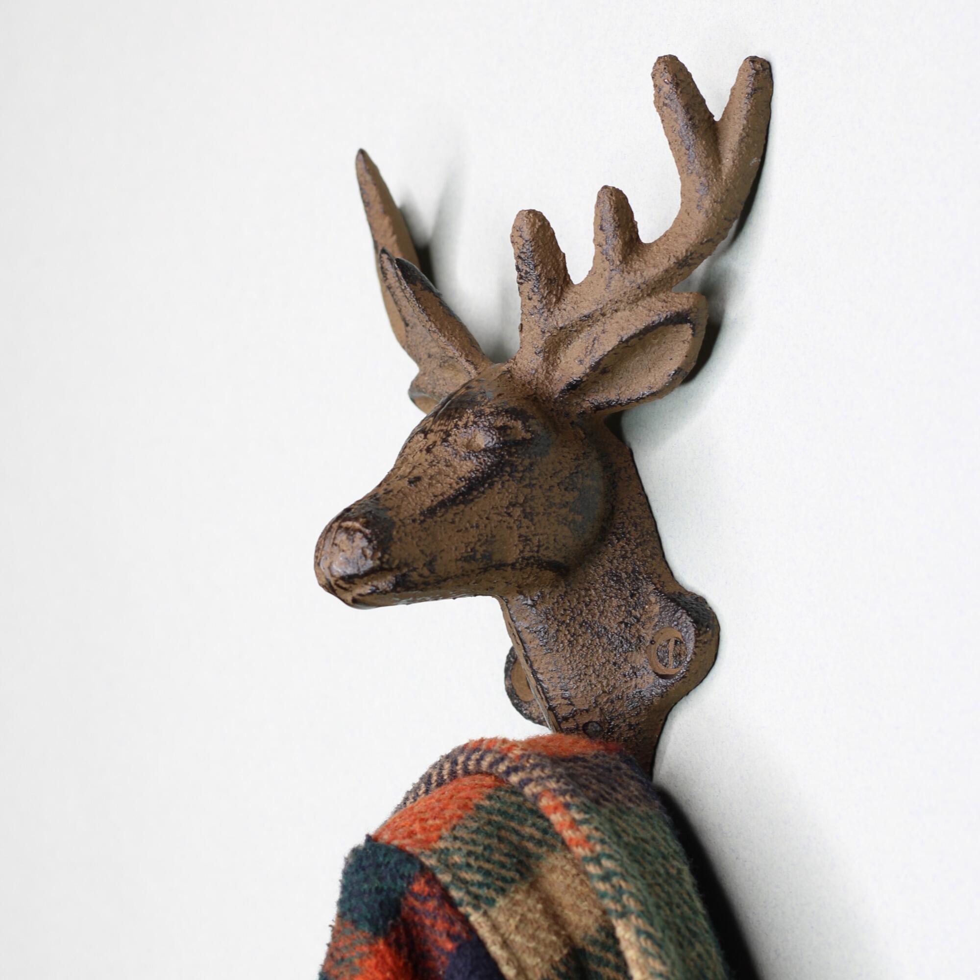 Side profile of a heavy-duty deer head wall hook showing the depth and sturdy cast iron construction for hanging heavy coats.