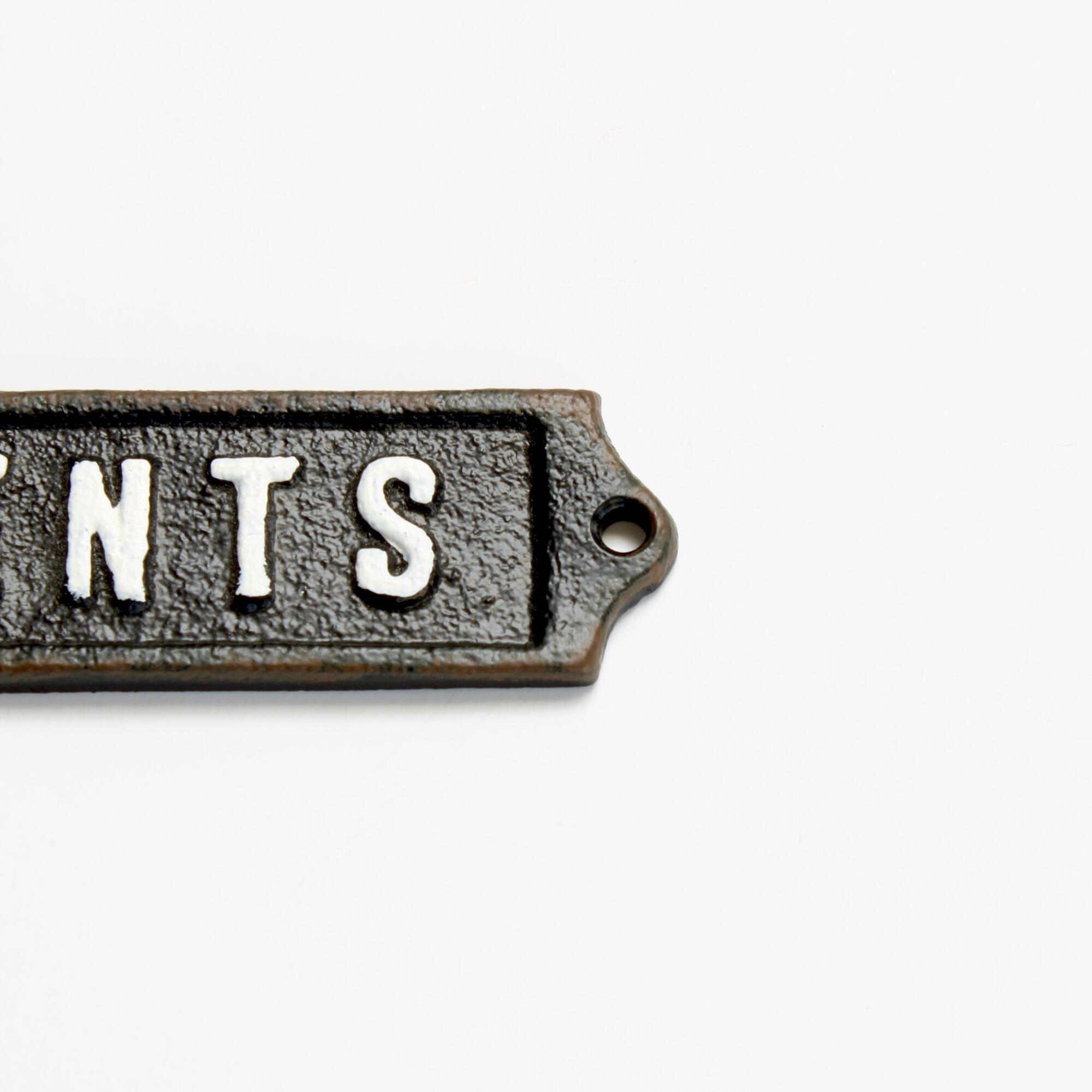 Closeup of a vintage style gents bathroom sign with a hand painted finish