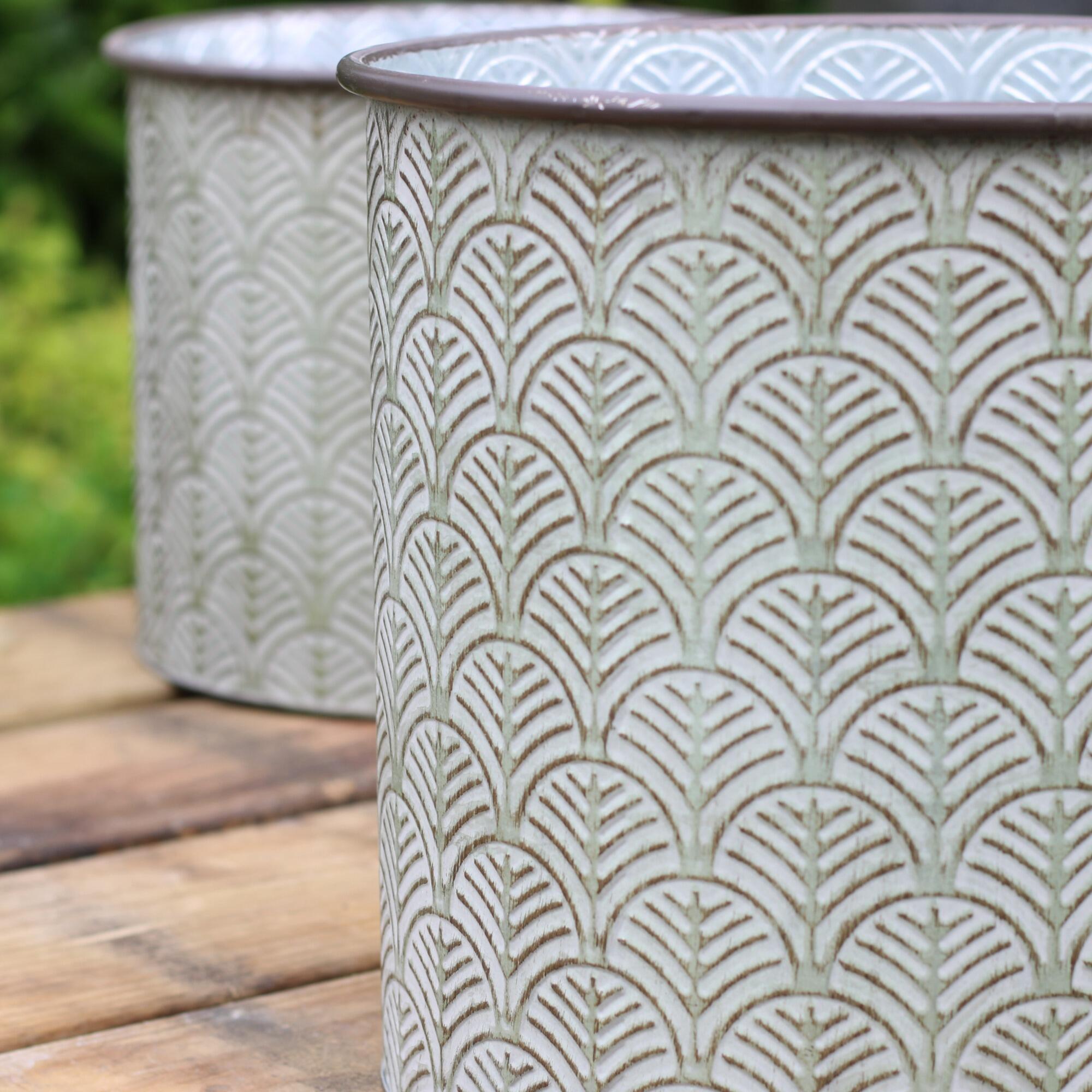 Garden planter with an embossed art deco fan leaf motif.