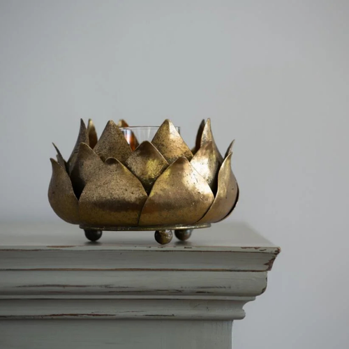 Metal artichoke candle holder with a rustic gold finish