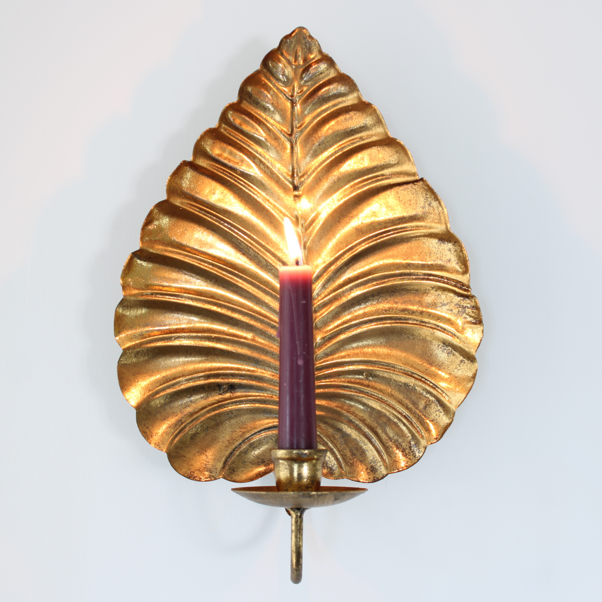 Candle sconce with aged gold finish.