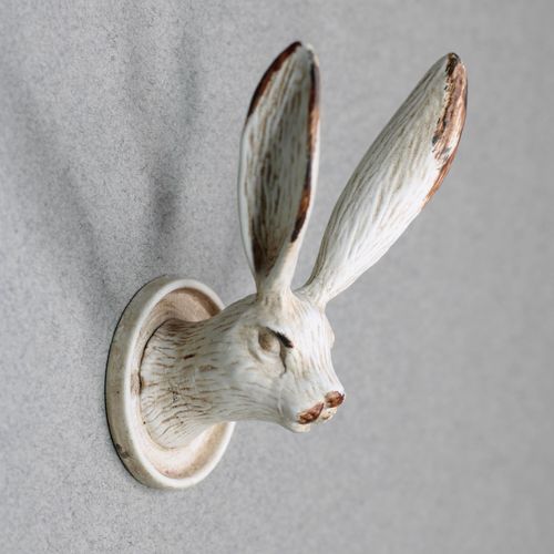 Detailed side view of a rustic rabbit head wall hook featuring long upright ears.