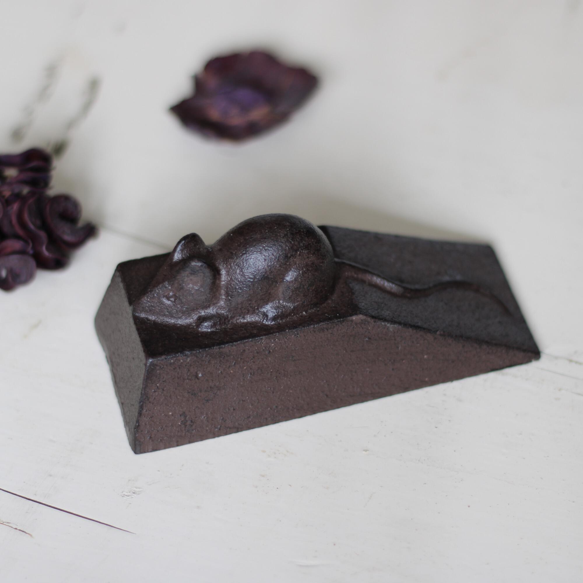 Heavy cast iron door wedge.