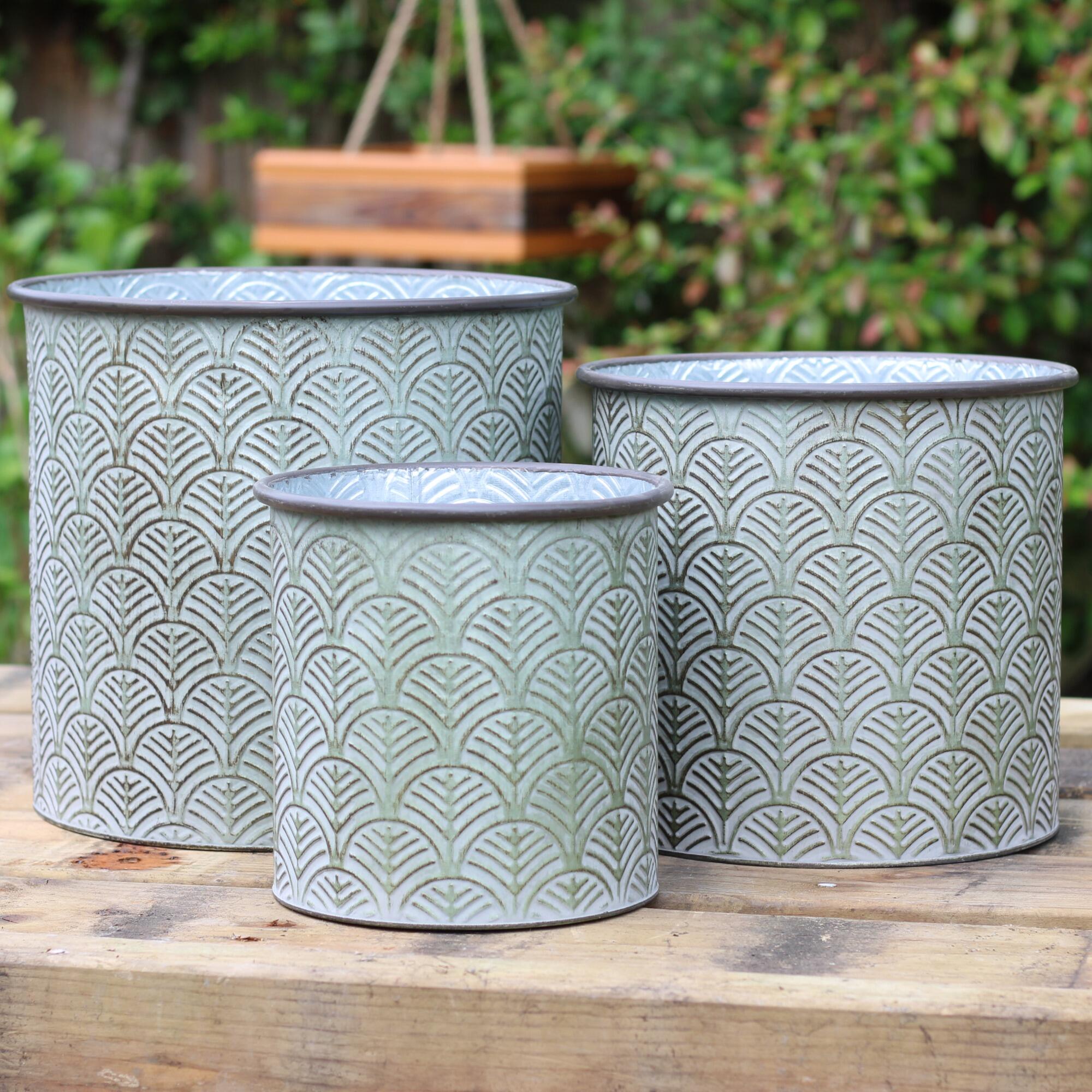 Set of three garden planters with a rustic green finish.