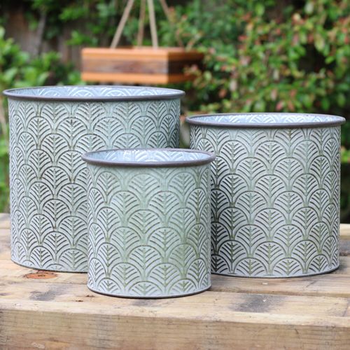 Set of three garden planters with a rustic green finish.