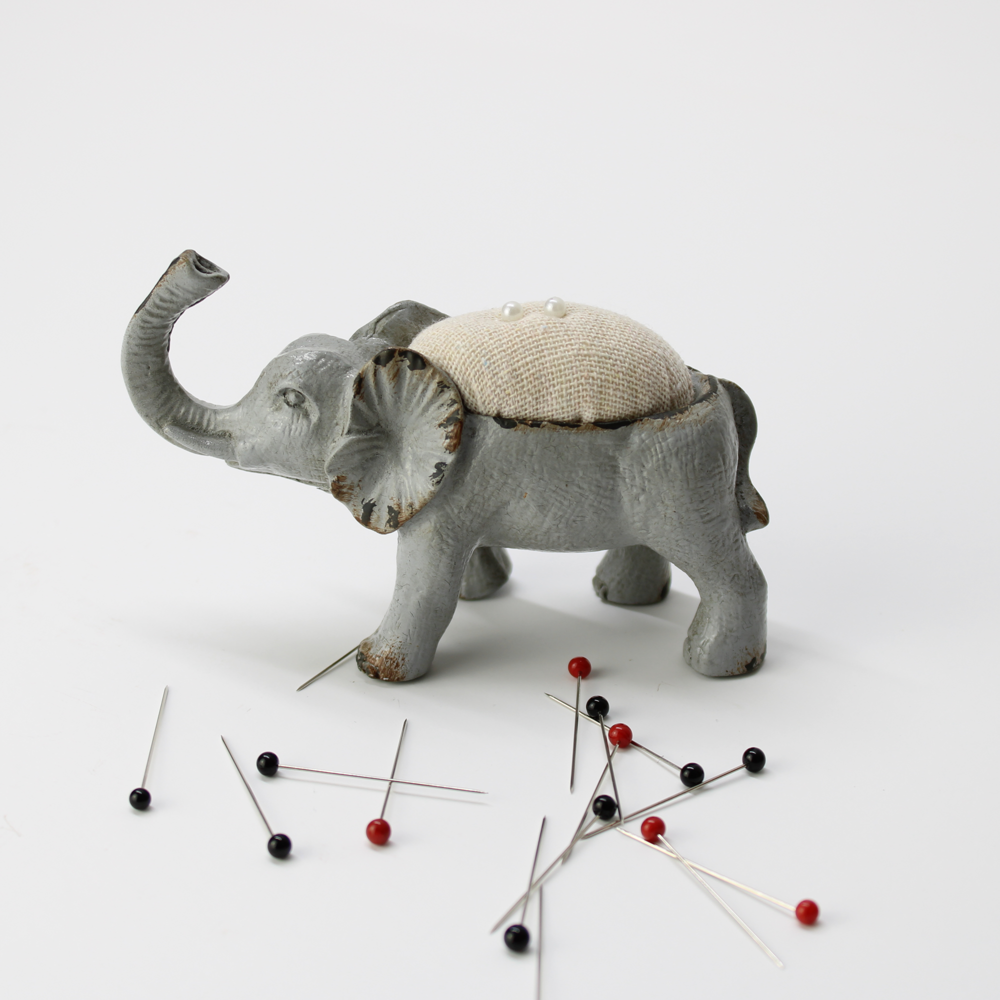 Vintage cast iron elephant pin cushion with a distressed paint finish