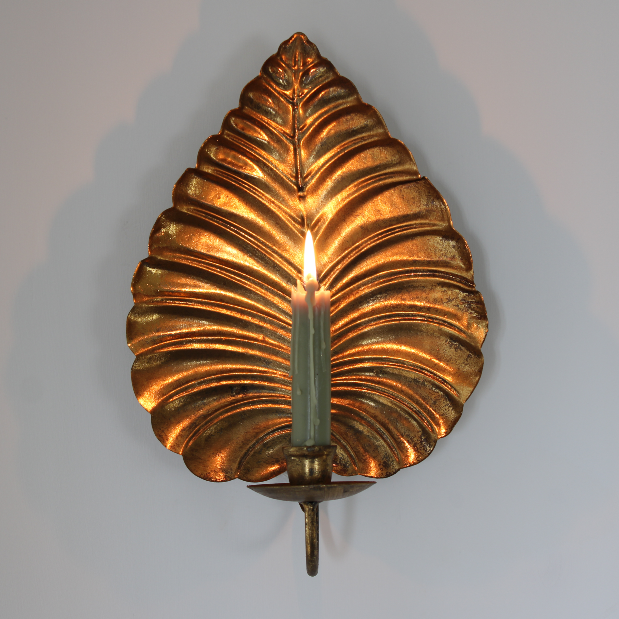 Gold wall candle holder.