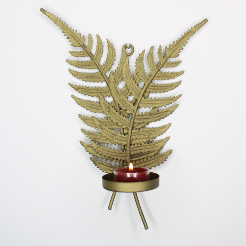 Gold fern leaf tealight candle sconce with rustic red candle.