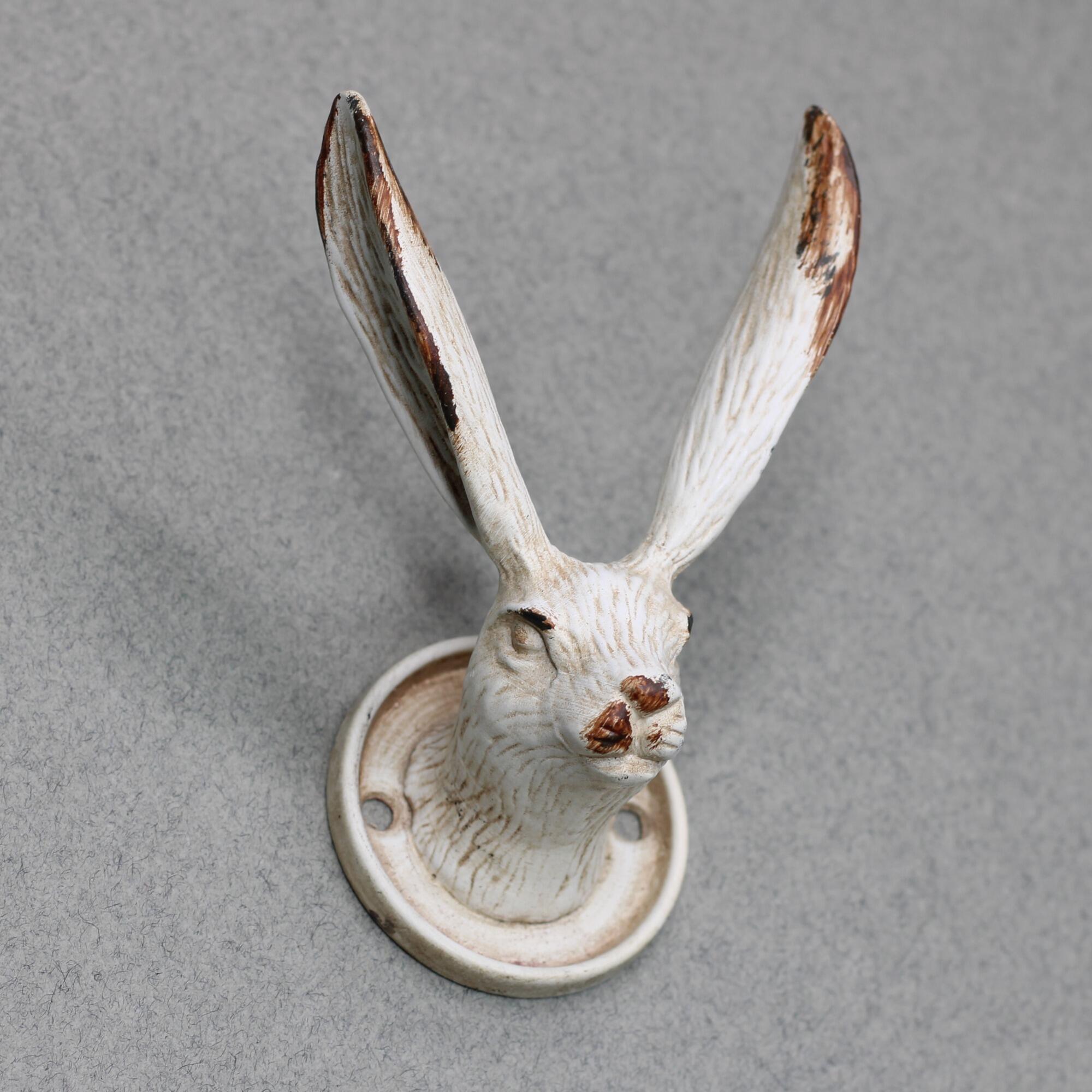 White antique style decorative hare head hook for coats and hats.