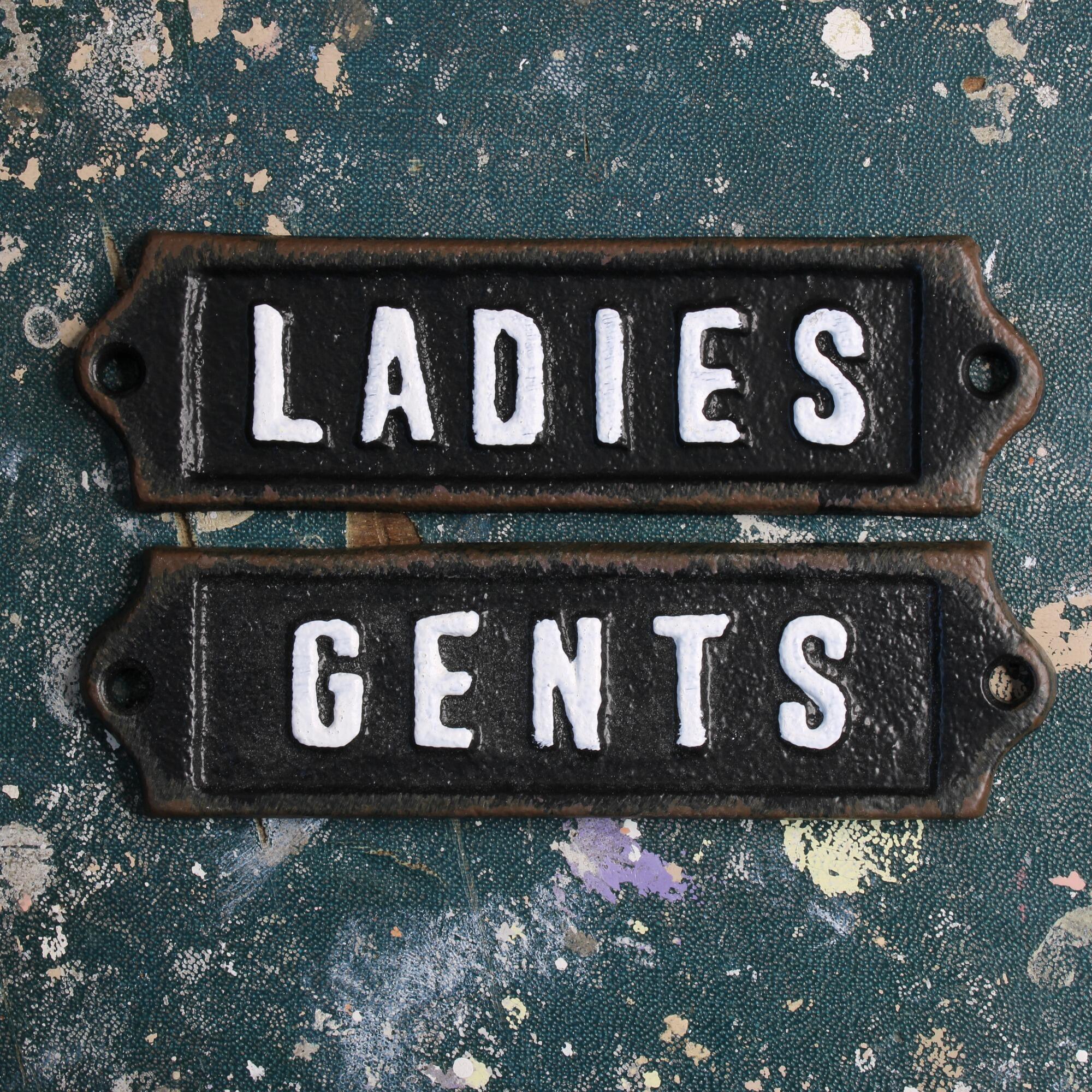 Period style restroom signs set with chipped paint