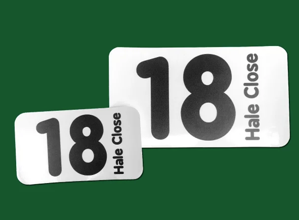 white sticker with the number 18 in black on a green background