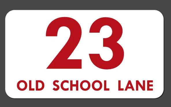 white sticker with red number 23 and red writing