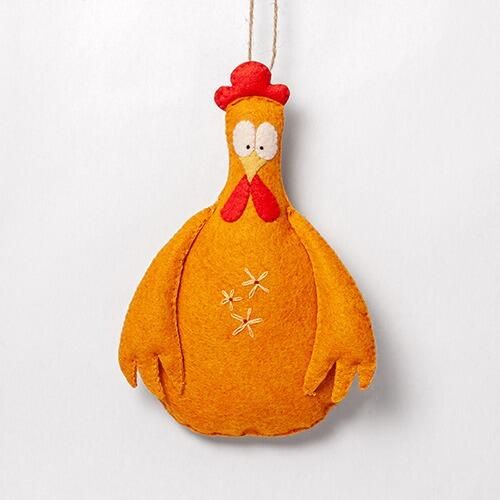A 3D padded felt chicken named Onion with a bright orange body, red comb and wattle, and delicate white embroidered flowers on its chest.