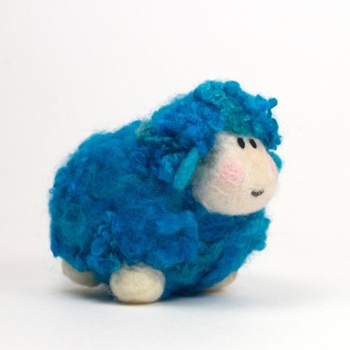A 3D needle-felted sheep named Woollie with a vibrant turquoise curly fleece, a white face, and rosy pink cheeks.