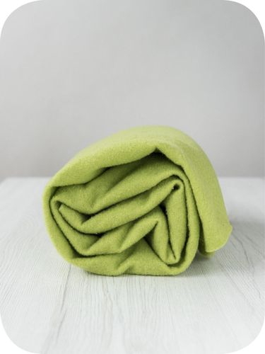 A roll of vibrant lime green Caipirinha extra fine merino wool prefelt.