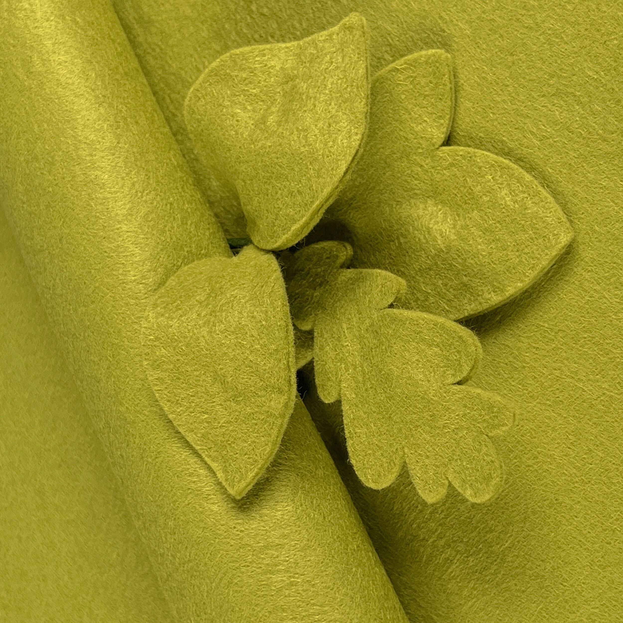 Bright Meadow Green wool-blend felt sheet shown with decorative leaf cut-outs, highlighting its soft matte texture and non-fray edges.