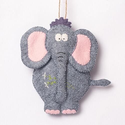 A 3D padded felt elephant named Ethel with a grey body, large pink-lined ears, a purple tuft of hair, and embroidered floral details on her side.