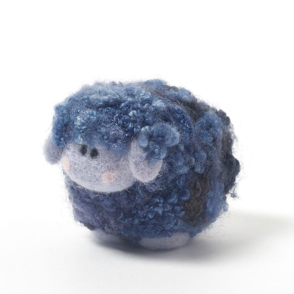 Blueberry the Ice Cream Woollie needle felting kit box and a finished fluffy blue sheep with curly hand-dyed Blue Faced Leicester fleece.