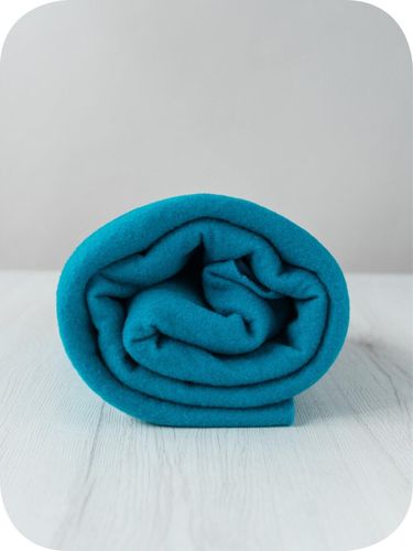 A roll of vibrant, deep Cobalt blue extra fine merino wool prefelt.