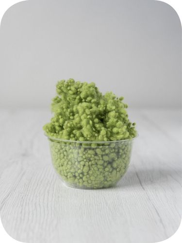 green wool nepps in a 5g portion for adding texture to felting and spinning projects