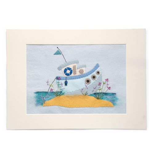 Completed mixed media embroidery project featuring a blue and white felt fishing boat traced and cut by hand, sitting on a yellow felt sandbank, set against a light blue felt sky with a needle-felted turquoise sea.