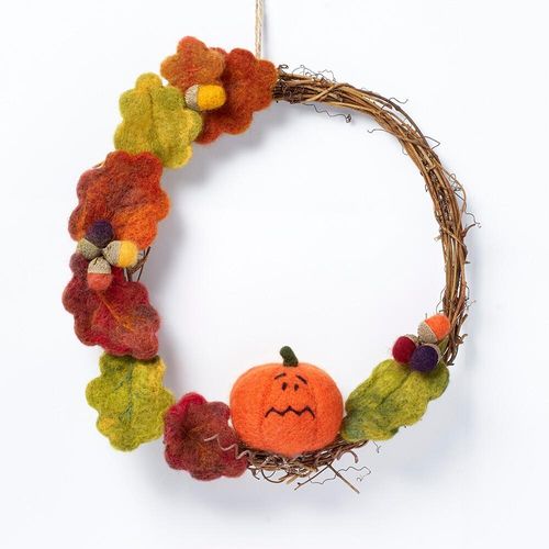 Autumn-themed needle felting kit featuring a round twig base, a characterful orange pumpkin with a green stem, variegated red and green oak leaves, and acorns finished with real natural acorn cups.