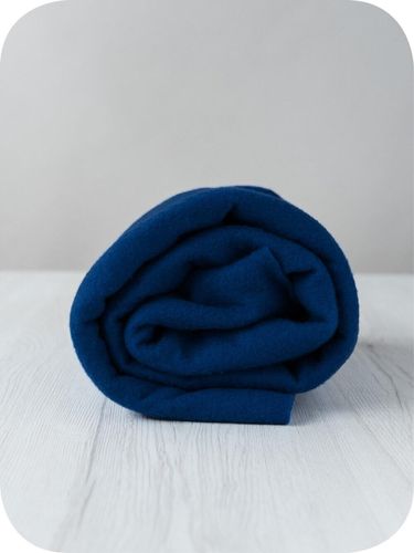 A roll of deep, midnight blue Evening extra fine merino wool prefelt.