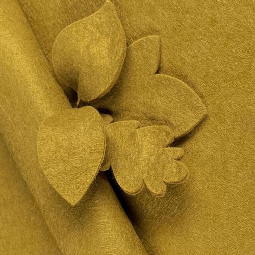 Warm Mustard yellow wool-blend felt sheet shown with decorative leaf cut-outs, highlighting its earthy ochre tone and clean, fray-free edges.