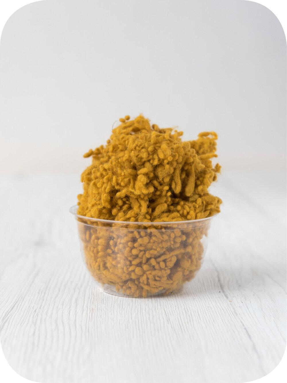 saffron yellow wool nepps in a 5g portion for adding texture to felting and spinning projects