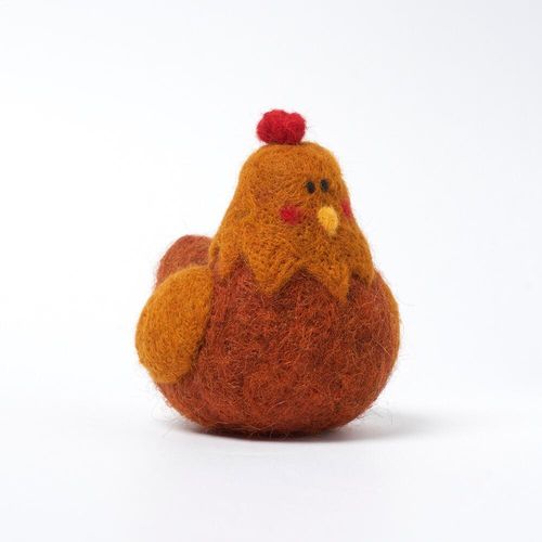 Cute needle-felted brown and orange chicken figurine with a red comb, yellow beak, and rosy cheeks, from a beginner felting kit.
