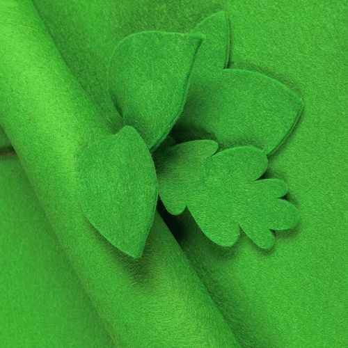 Vibrant Emerald green wool-blend felt sheet shown with decorative leaf cut-outs to highlight its premium matte texture and clean-cut edges.