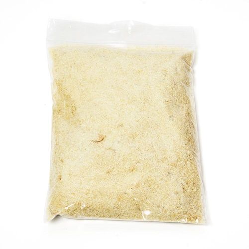 A scoop of pale, delicate olive oil soap flakes for wet felting.