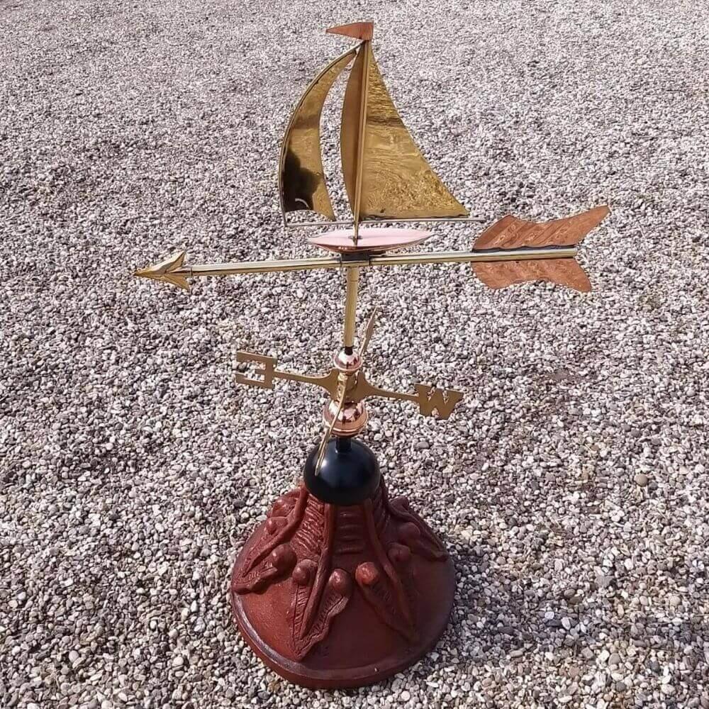 Sailboat weathervane installed on a round ridge tile cap