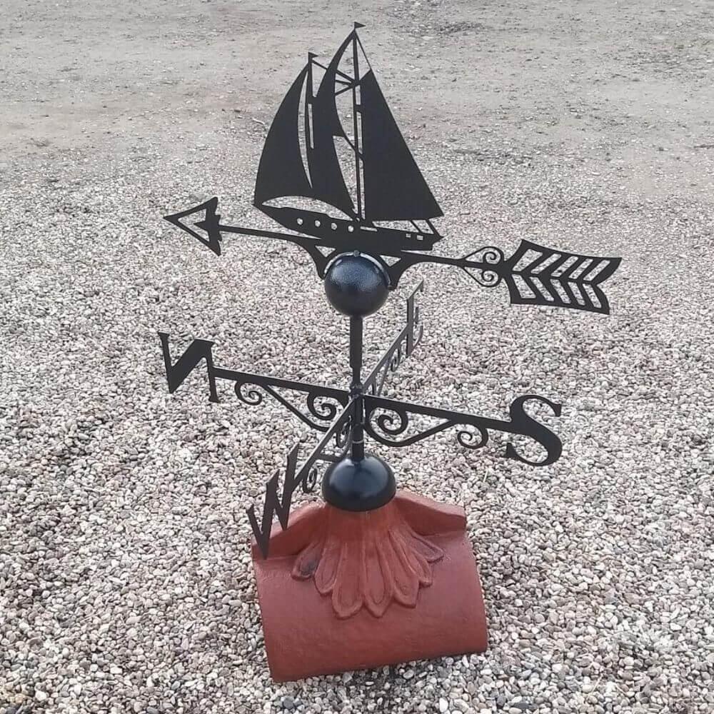 Sailboat steel weathervane installed on a half round roof ridge