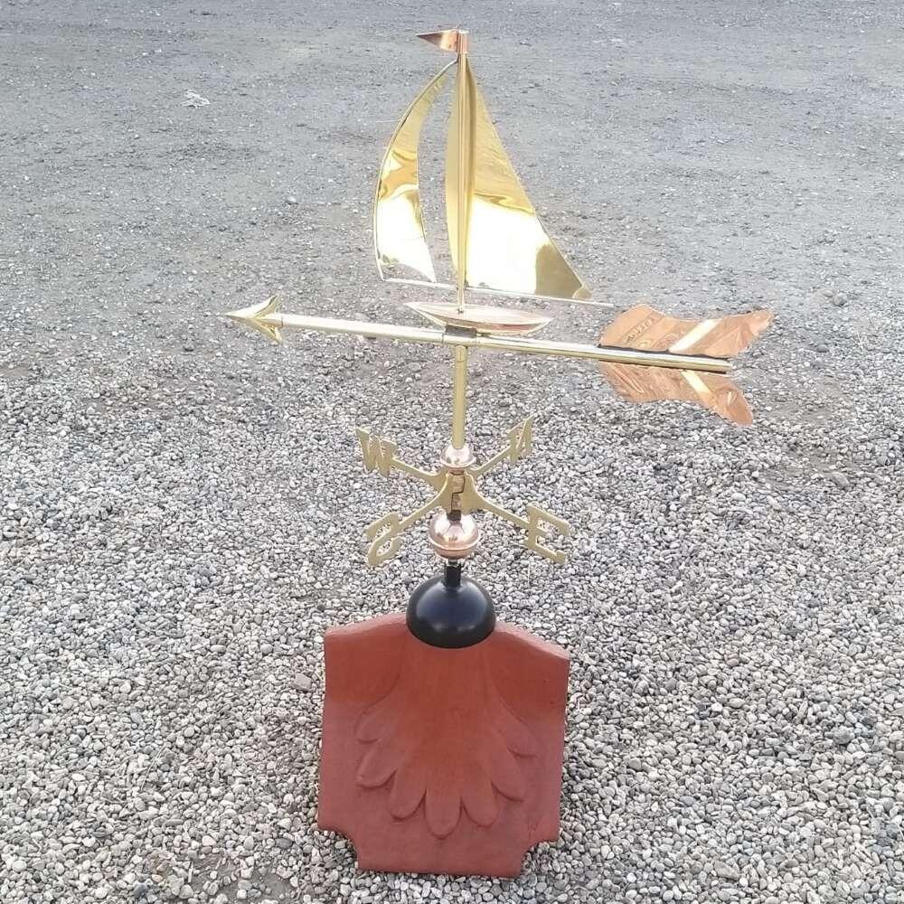 Sailboat weathervane installed on a ridge tile finial fitting with multiple angle options