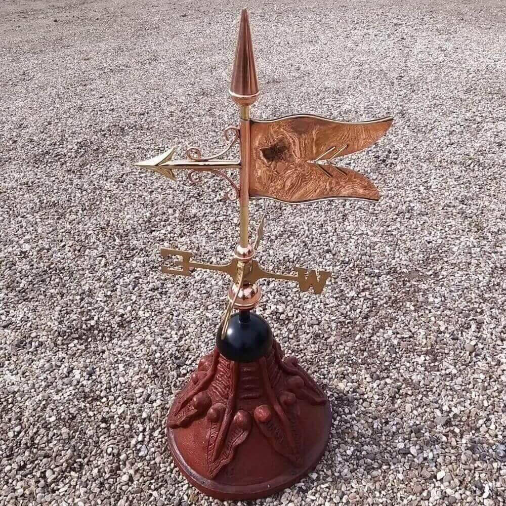 Banner weathervane fixed to a round ridge tile cap