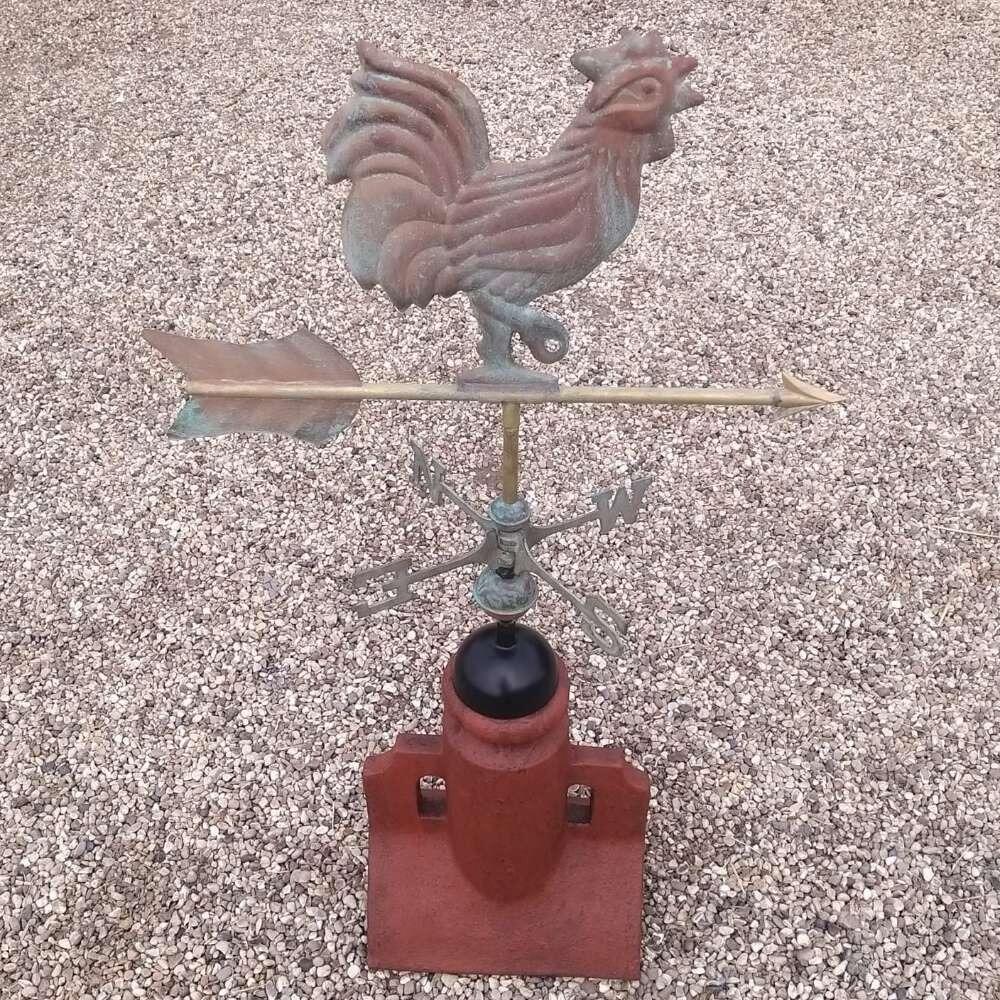 Verdigris cockerel weathervane on a 90 degree ridge tile finial