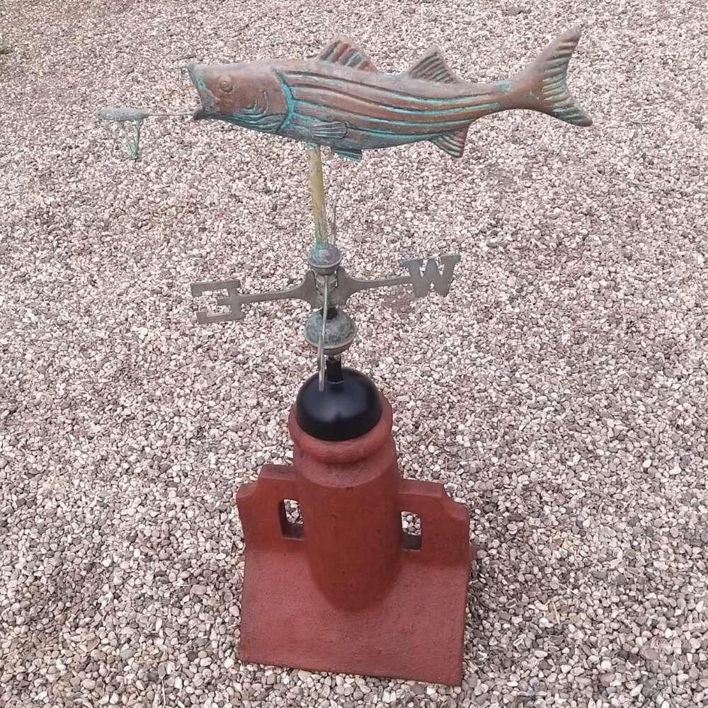 Verdigris bass and lure weathervane on a 45 degree ridge tile finial