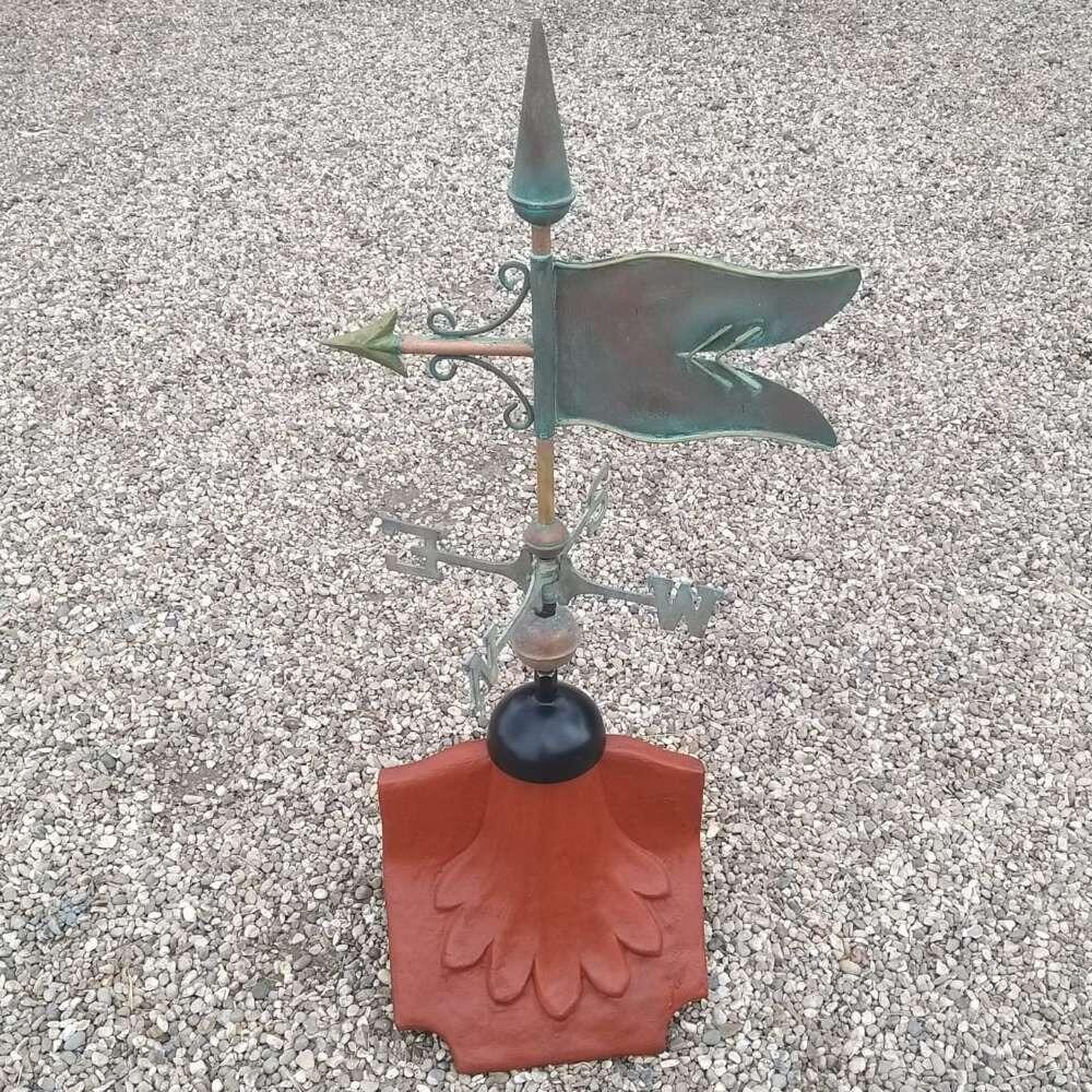 Banner verdigris weathervane on a ridge tile finial fitting with multiple angle options