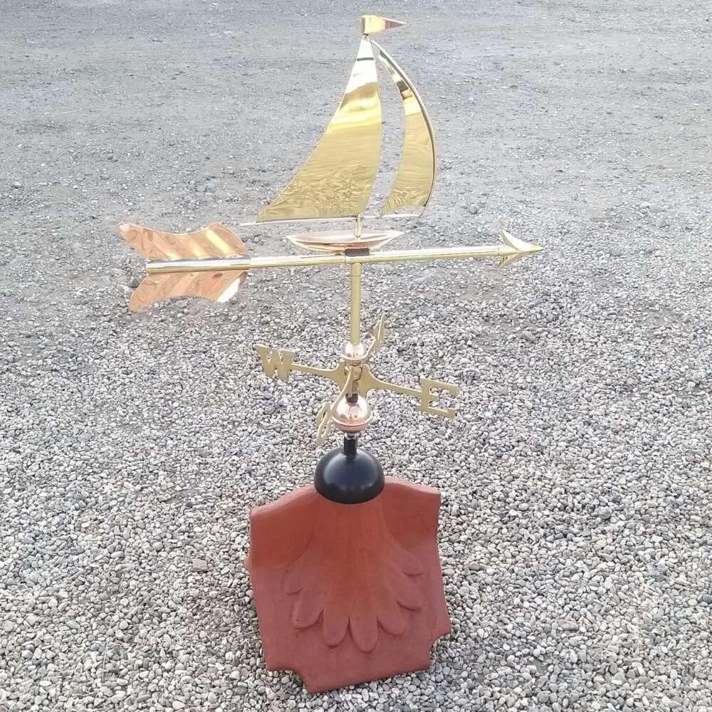 Sailboat weathervane installed on a ridge tile finial fitting with multiple angle options