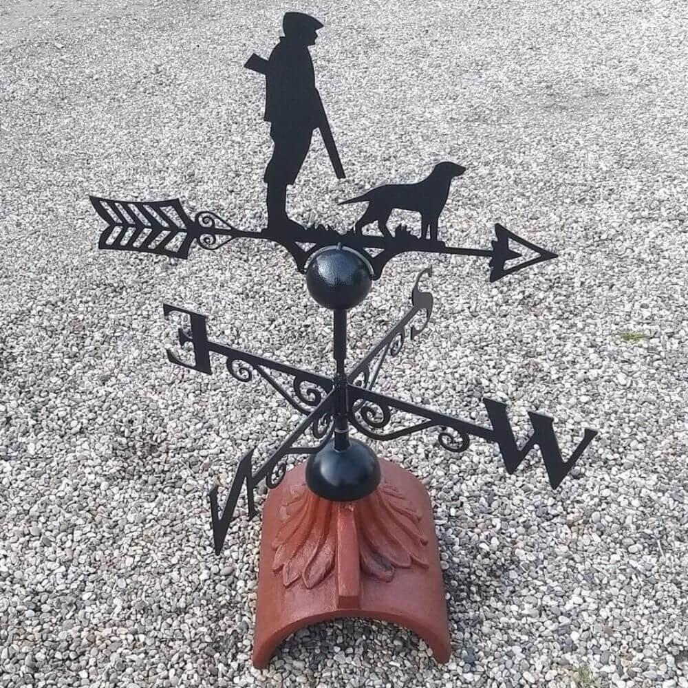 Gun down hunting weathervane mounted on a half round ridge