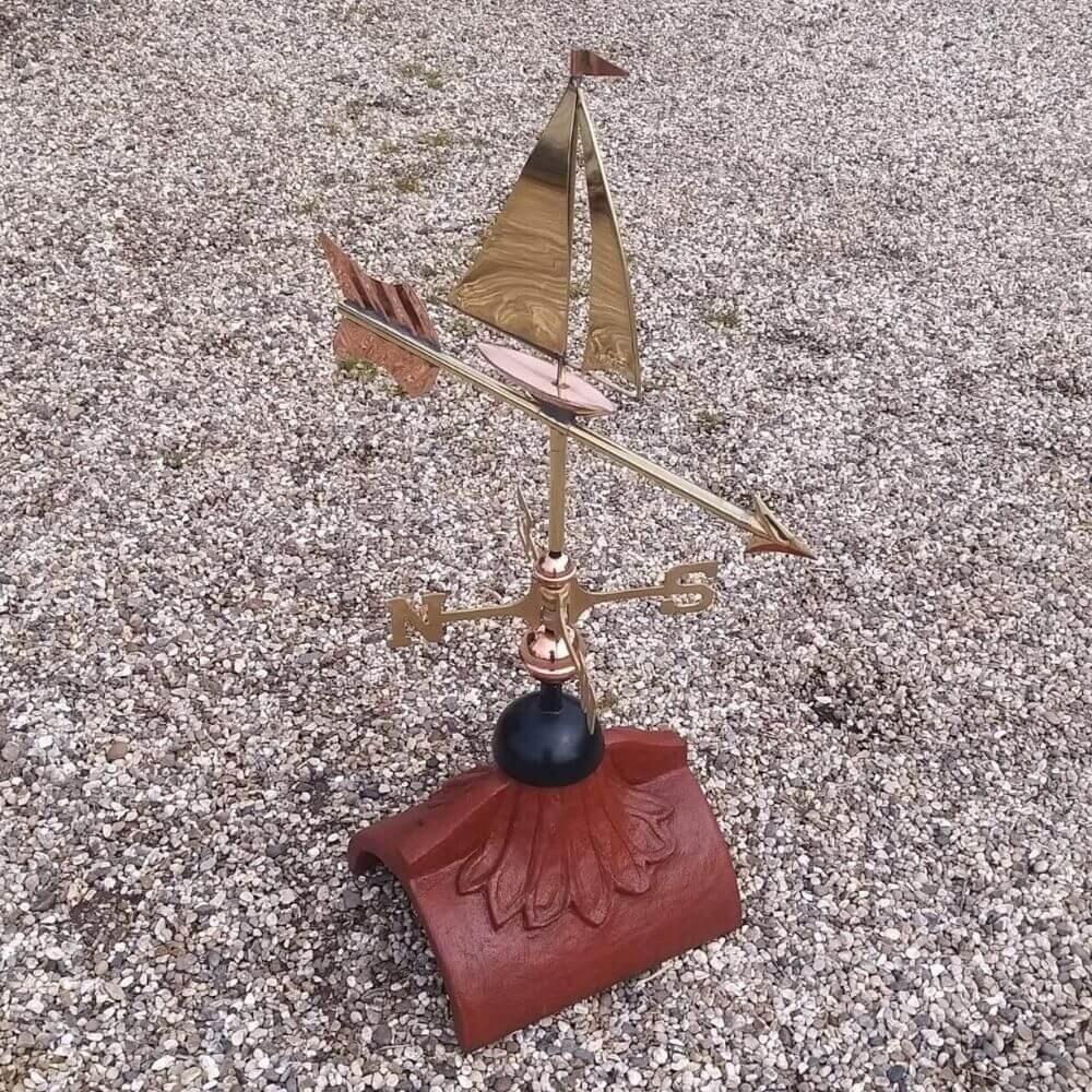 Sailboat weathervane fitted to a square ridge tile