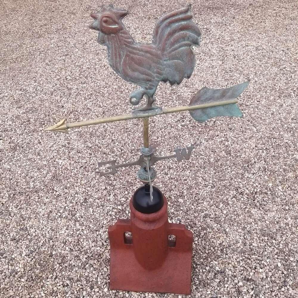 Verdigris cockerel weathervane on a 90 degree ridge tile finial