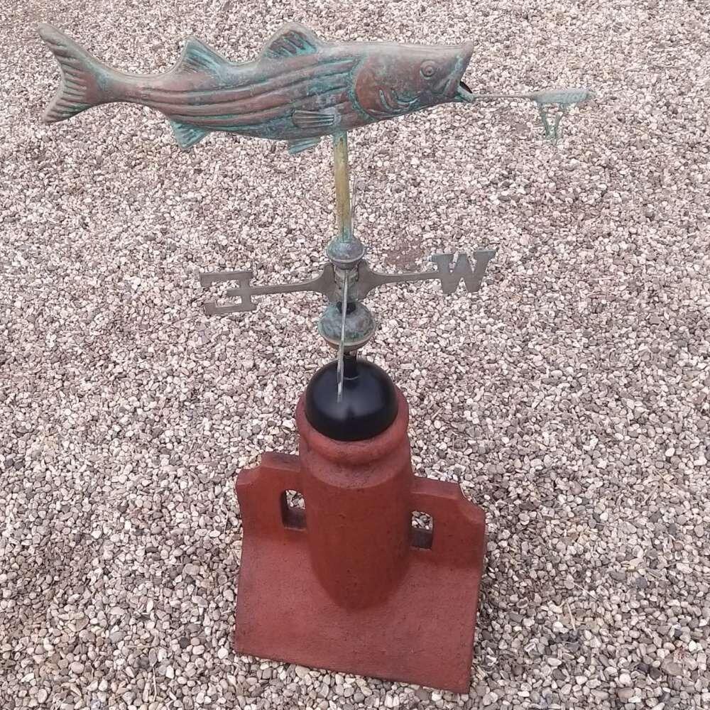 Verdigris bass and lure weathervane on a 45 degree ridge tile finial