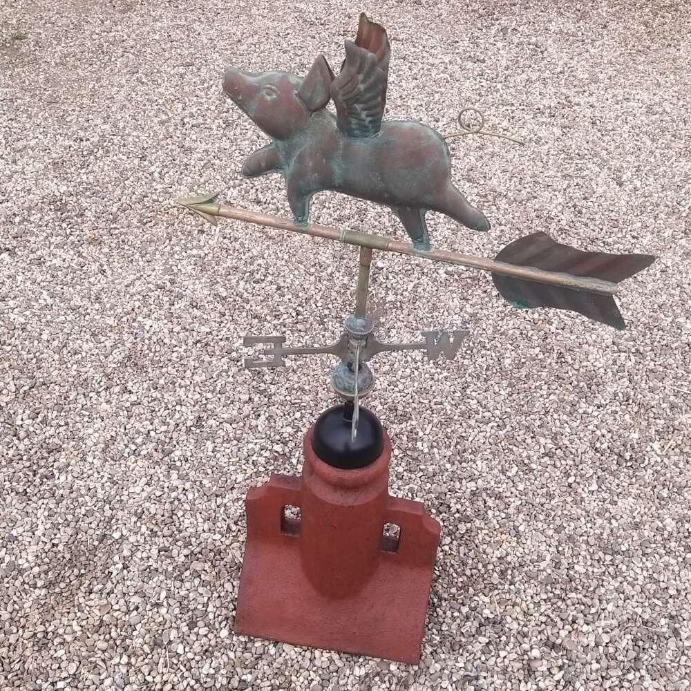 Flying pig verdigris weathervane supplied on a 90 degree ridge tile