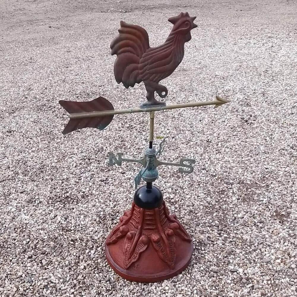 Cockerel weathervane fixed to a round ridge finial