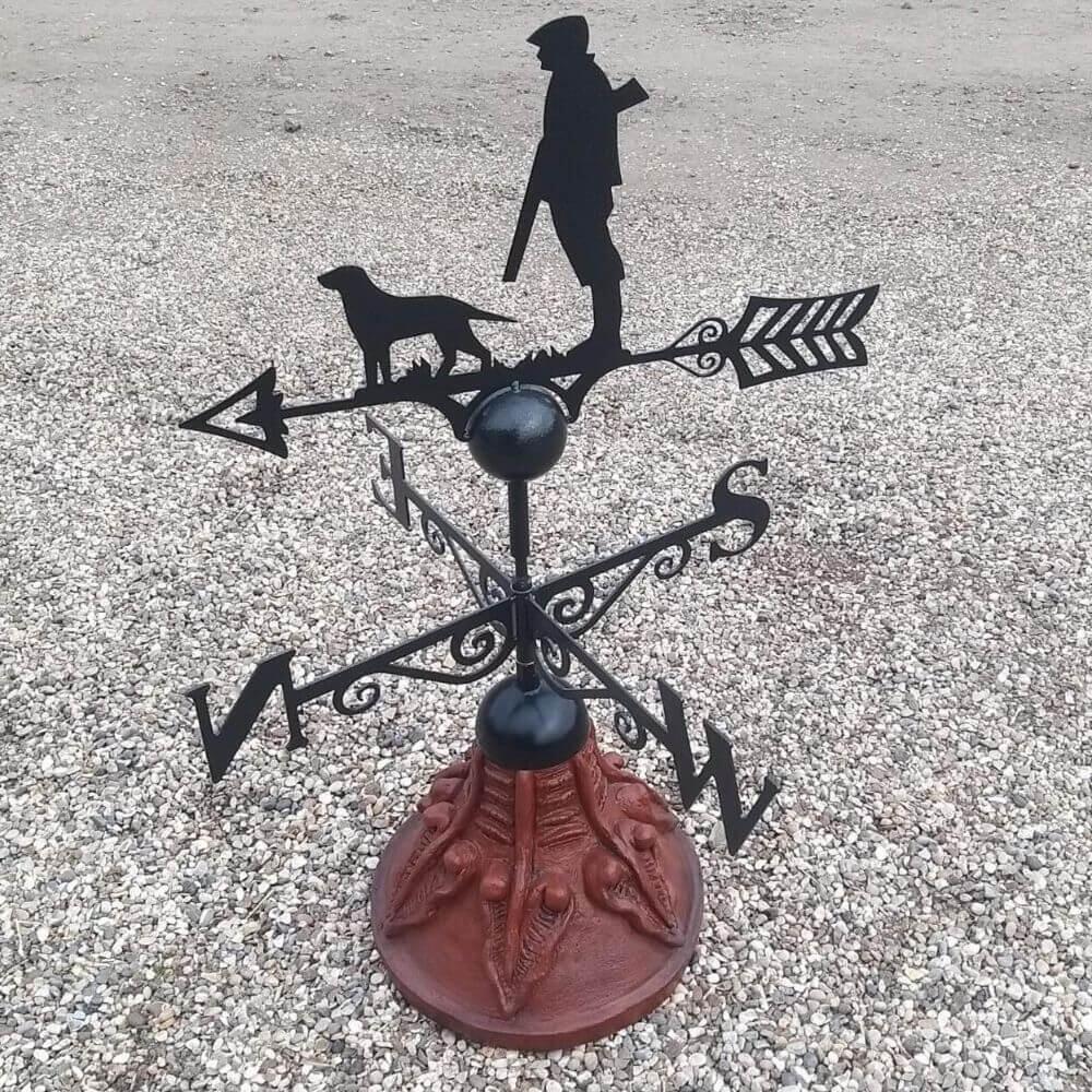 Gun down hunting weathervane installed on a round ridge tile base